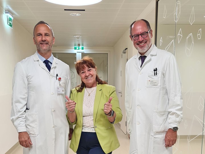 Univ.-Prof. Dr. Andreas F. Zierer (li.) und Prim. Priv.-Doz. Dr. Clemens Steinwender (re.) mit ihrer erfreuten Mitralklappen-Patientin