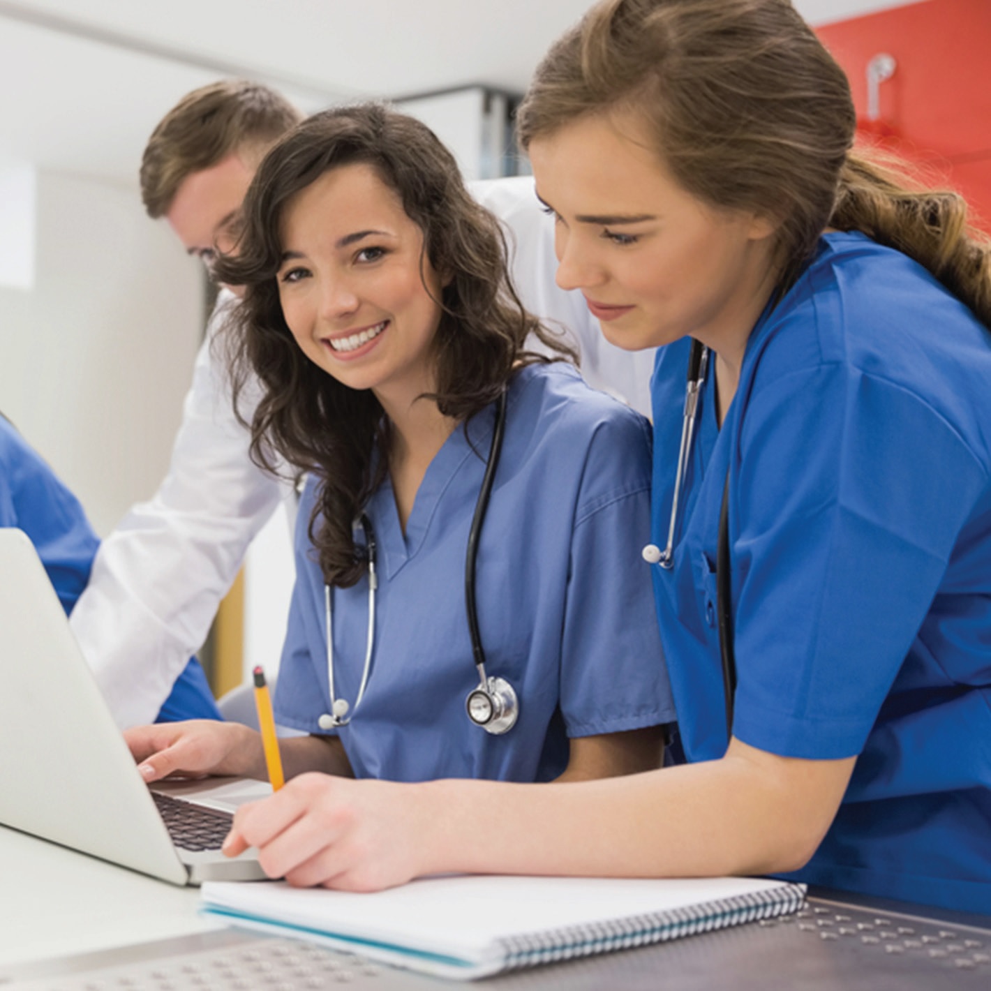 Medizinstudierende mit Laptop in Lehrsaal 